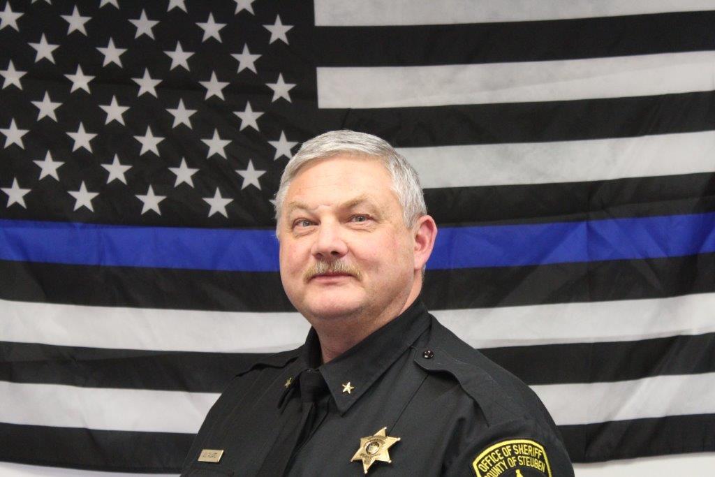 Sheriff James L Allard In Front of American Flag